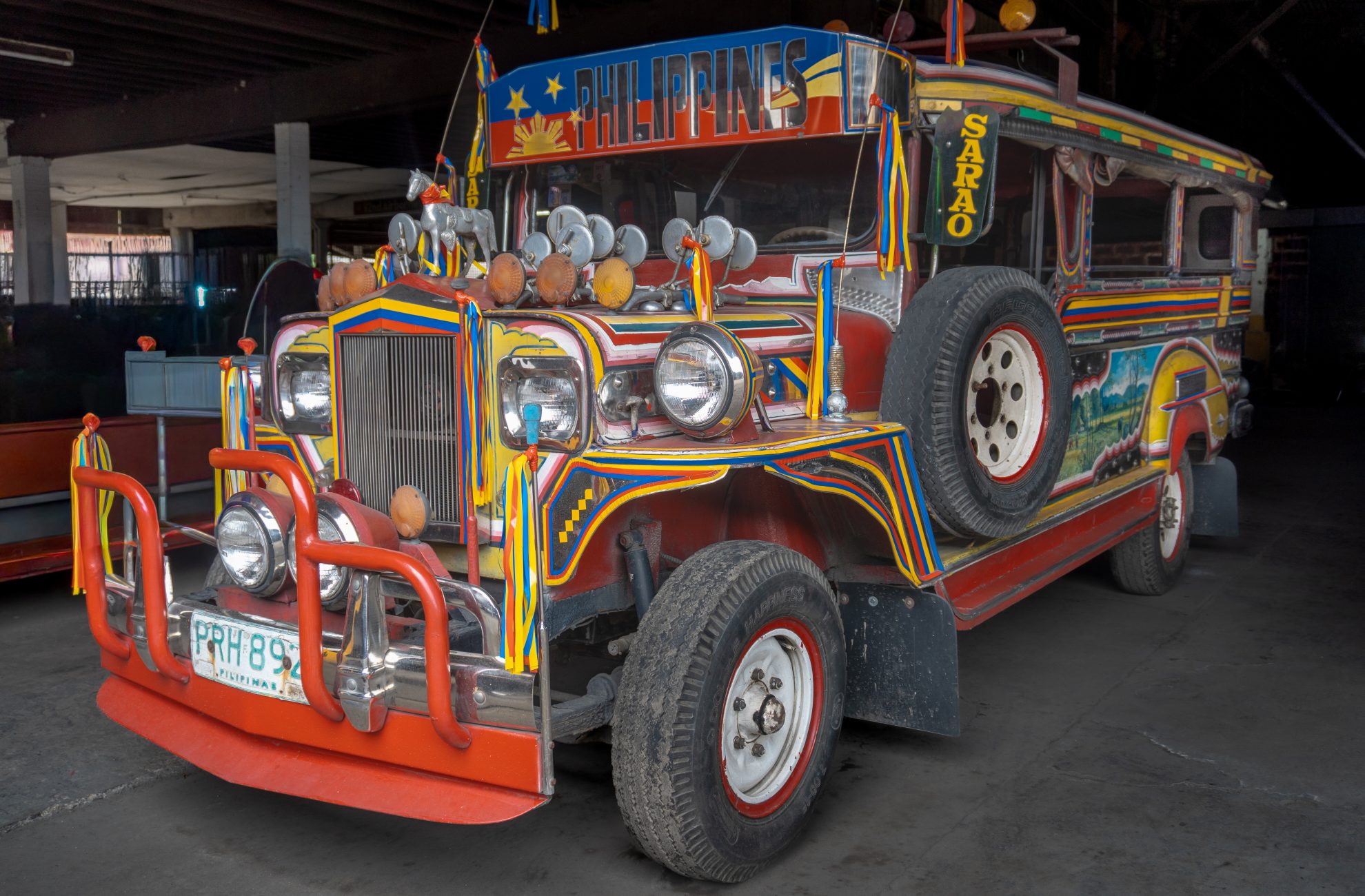 A privately owned Sarao jeepney decorated with both hand-painted and sticker art styles.